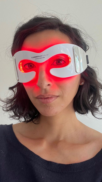Allure contributing commerce editor Deanna Pai wearing the Currentbody LED Eye Perfector